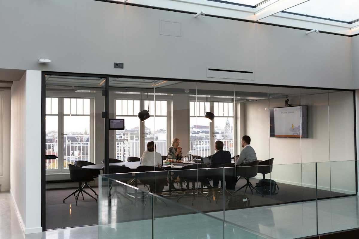 People seated around a table in a meeting