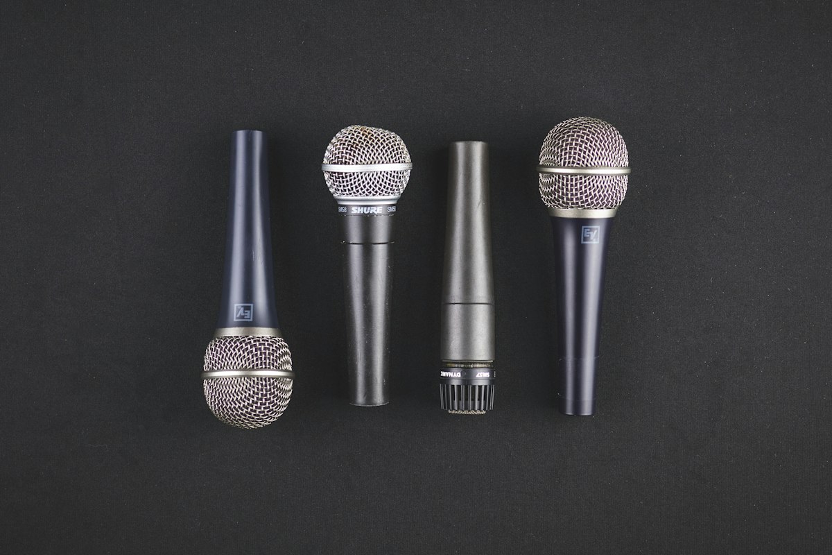 Four microphones at a podium